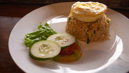 Indonesian Fried Rice with Fried Egg and Fresh Vegetables