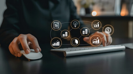 Person using a computer mouse and keyboard with glowing digital business analytics icons and charts overlayed
