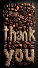 Creative arrangement of coffee beans spells out thank you in rustic decor style