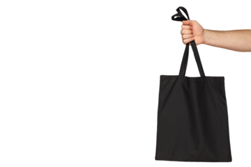 A person lifts a comfy black tote bag, isolated on white, PNG