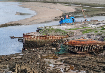 old abandoned sunken ship in the water at the ship cemetery