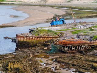 old abandoned sunken ship in the water at the ship cemetery