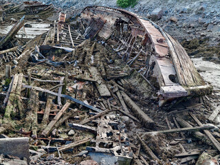 old abandoned sunken ship in the water at the ship cemetery