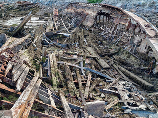 old abandoned sunken ship in the water at the ship cemetery