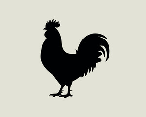 Silhouette of a proud rooster standing against a light background