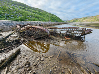 old abandoned sunken ship in the water at the ship cemetery wood pattern