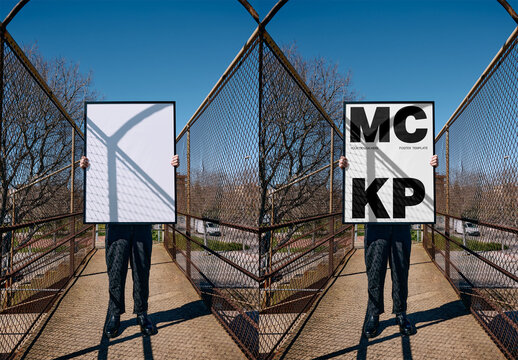 Mockup Of Man Holding Vertical Customized Framed Artwork Over Face