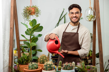 Flower shop assistant watering cactuses and looking contented