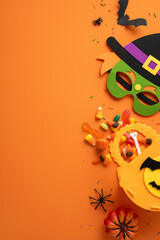 Halloween vertical themed decorations featuring a mask and pumpkin basket with candies and spiders