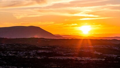 Vibrant sunset casting golden light over a volcanic landscape
