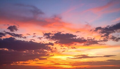 Vibrant sunset hues paint the sky with scattered clouds