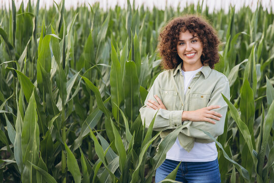 Agronomist working in corn field smiling with crossed arms - Powered by Adobe