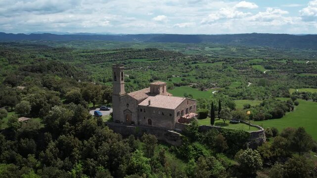 Beautiful hilltop church with beautiful landscape in the background in Catalonia, Spain. High quality 4k aerial drone footage