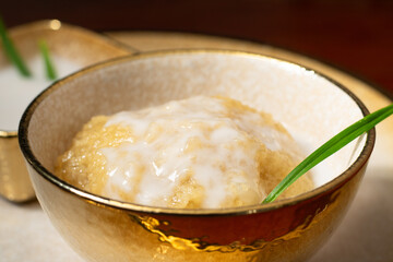 Boiled Sorghum. Traditional Thai desserts call name Kanom Khao Fang. Millets food. Dolly scenes of delicious dessert served with coconut milk.