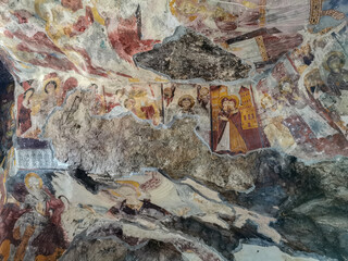 Ancient Rock Monastery with Colorful Frescoes and Historic Architecture