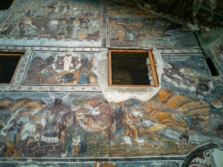 Ancient Rock Monastery with Colorful Frescoes and Historic Architecture