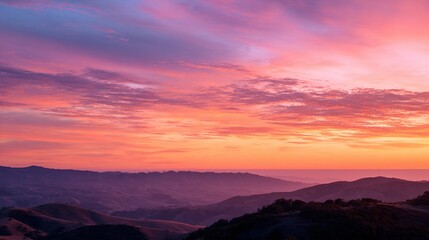 Fototapeta premium Pink And Orange Sunset Over Rolling Hills Silhouette. High quality