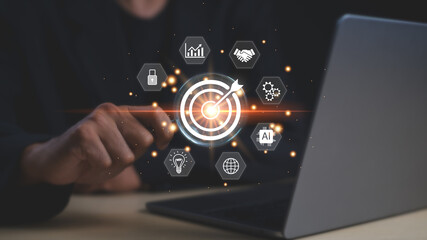 A person interacting with a digital target interface symbolizing business strategy and artificial...