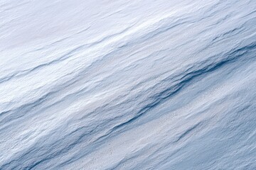 Obraz premium Abstract textured background featuring soft waves of light blue and white tones, creating a serene and calming visual atmosphere for design projects