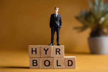 Hybrid workplace model concept with figurine on blocks emphasizing boldness in modern work environments