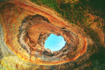 Coastal rocky seascape, view inside the cave Benagil in Algarve region in the Atlantic Ocean,...