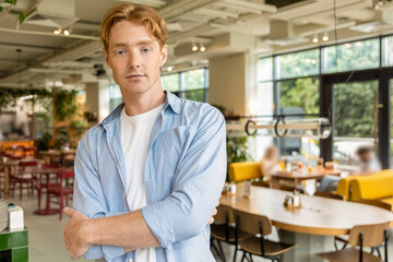 Ginger handsome young guy looking confident and positive
