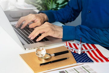 Concept of businessman using tablet to contact business and search for flight schedule information...