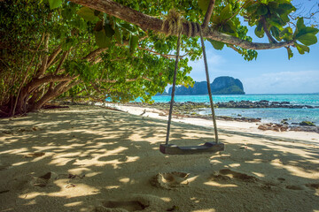 Wooden swing on a paradise beach on Bamboo Island in Phi Phi Islands, Hat Noppharat Thara National...