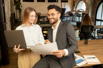 Two young professionals working in the office and looking involved