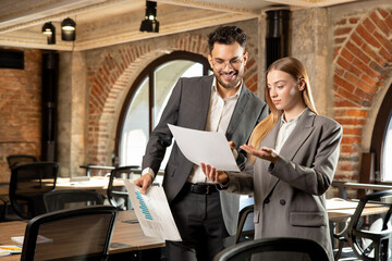 Two young professionals working in the office together