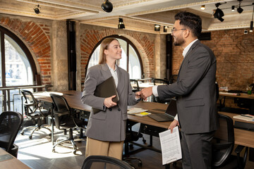 Two young professionals working in the office together