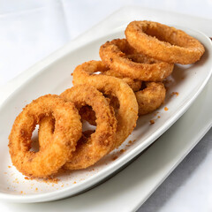 Crispy Golden Onion Rings Served on White Plate
