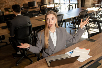 Cute long-haired blonde female manager working in the office
