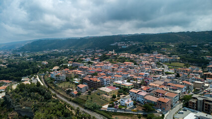 Naklejka premium Hilltop Town Near Tropea with Red Roofs and Railway – Aerial View