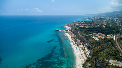 Coastal Beach with Umbrellas and Blue Sea
