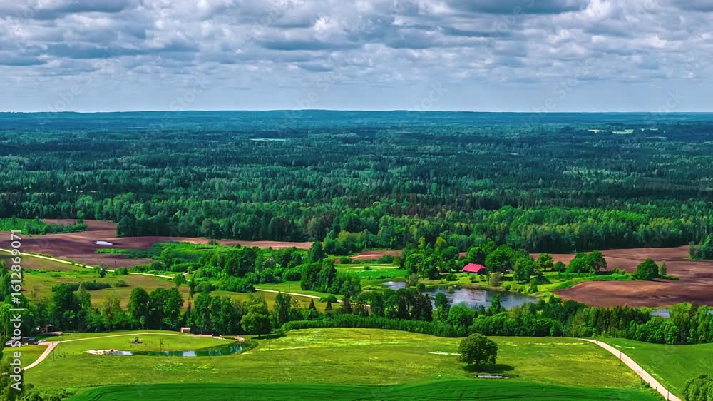 Aufkleber fast-motion hyperlapse showing forest and fields with dynamic shadows from moving clouds above.