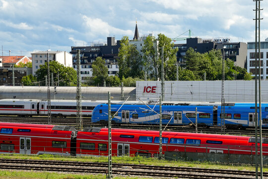 A red S-Bahn train, a white and blue Bayerische Oberlandbahn train and a white Intercity-Express (ICE) train at Donnersbergerbr&uuml;cke station in Munich, Bavaria