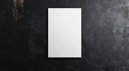 Blank white book or document on dark textured surface