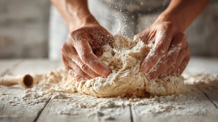 Fototapeta premium Flour dust fills the air as hands work the dough on a wooden countertop in a warm, rustic kitchen. The afternoon light adds warmth to the scene of preparation.