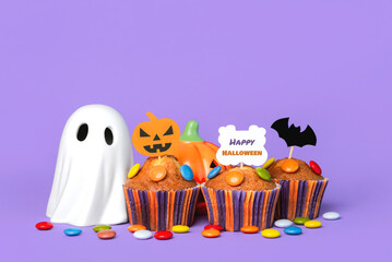 Closeup of homemade muffins,funny Halloween ghost and Halloween party decoration.Halloween concept background