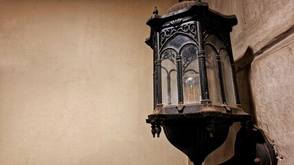 Antique outdoor lamp. An antique lamp on the wall of a classic building. © Limbong