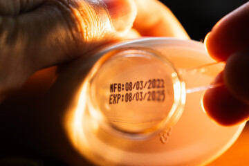 Reading Small Text of Manufacturing date and Expiration date on Bottom of Product with Magnifying Glass