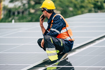 Worker inspects solar panels on a rooftop during daylight to ensure proper function and maintenance...