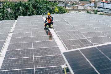 Solar panel technician inspects installation on rooftop in urban environment during daylight hours