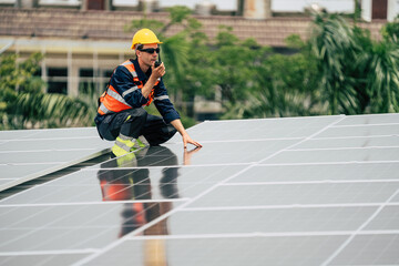 Worker inspects solar panels on a rooftop in an urban area during daylight hours