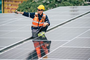 Solar panel technician inspecting installations on a rooftop during daylight