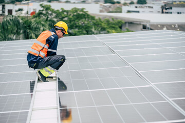 Worker inspects solar panels on rooftop during daylight in urban area