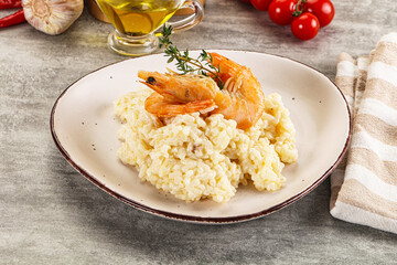Italian risotto with prawn served thyme