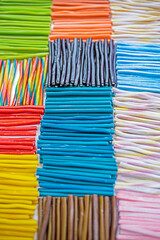 jelly candies with different flavors in the forms of multi-colored sticks or worms in a...
