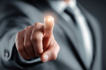 A businessman in a suit pointing at the front. A pose that represents leadership, choice, and decision.